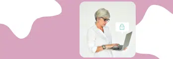 Imagem de uma mulher com cabelo grisalho usando óculos e trabalhando no computador portátil, promovendo segurança digital e LGPD