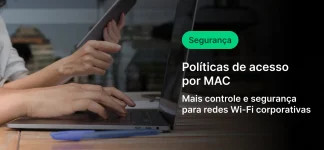 Pessoa utilizando laptop sobre mesa de madeira enquanto segura um tablet, em ambiente de escritório moderno. Na lateral direita, sobreposição escura com texto em português: “Segurança”, “Políticas de acesso por MAC” e “Mais controle e segurança para redes Wi-Fi corporativas”. Conceito de tecnologia, cibersegurança e gestão de acesso em redes corporativas.